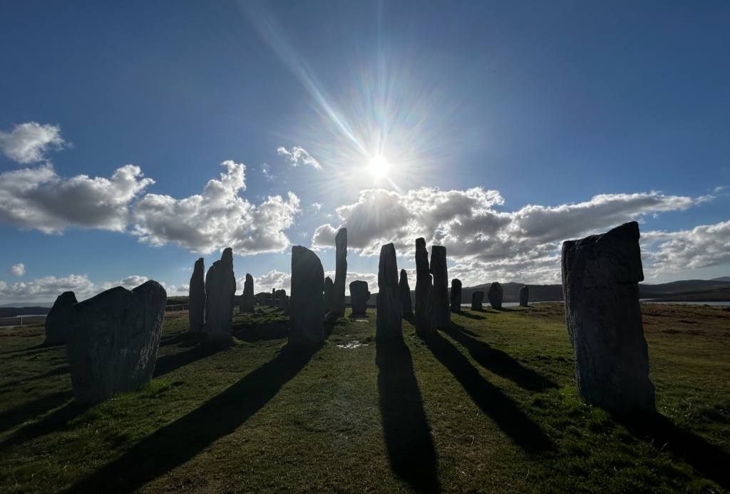 sun over Callanish standing stones